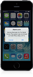 Image of iPhone with alarm notification using Alarm.com app.
